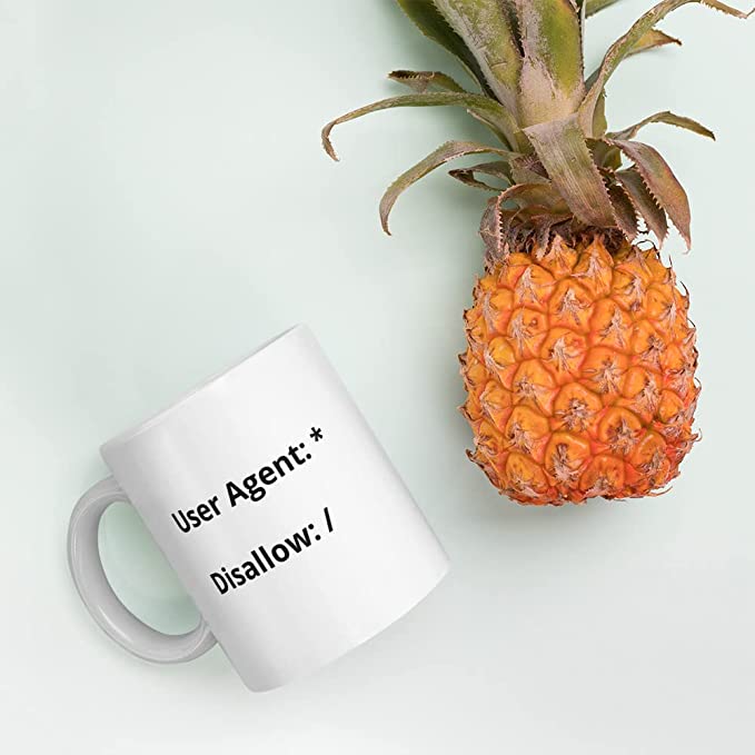 SEO coffee mug that shows a robots.txt file disallowing all user agents to all content.