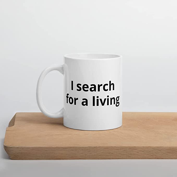 SEO coffee mug that says "I search for a living".